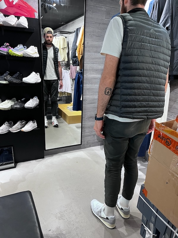 "Ich stehe mit skeptischem Blick vor einem Spiegel im Schuhgeschäft."